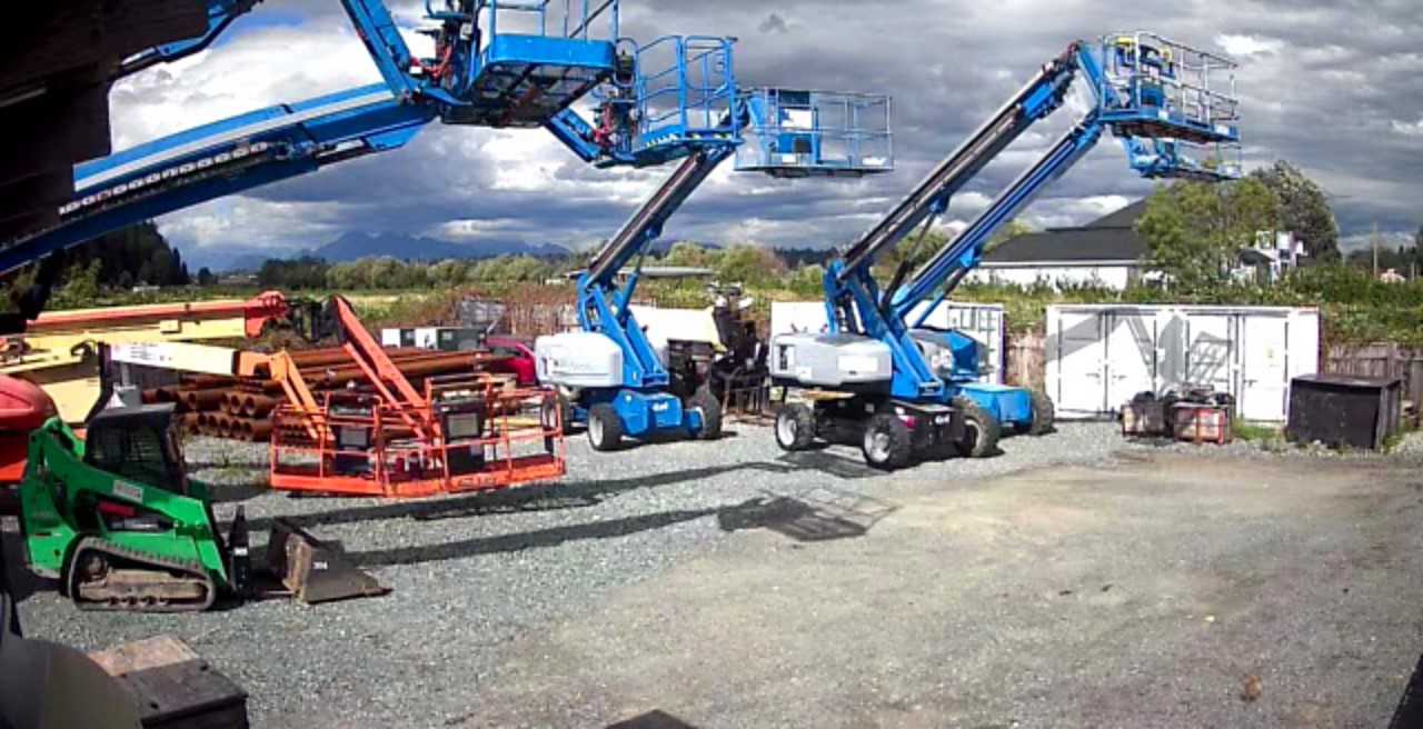 Genie boom lifts, a Bobcat and more equipment in the Global Lions Rental yard